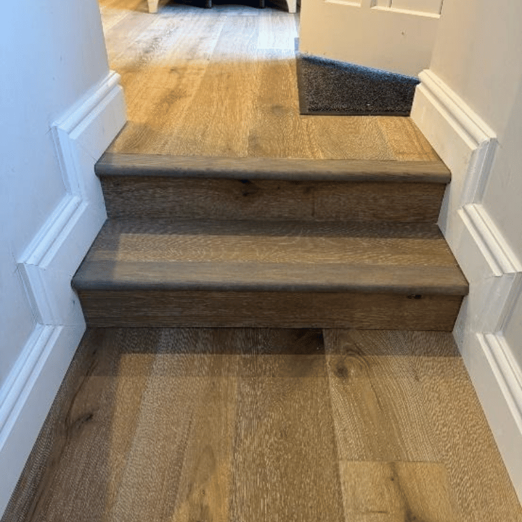 Showing the clean, continuous transfer of flooring between areas and stair detailing