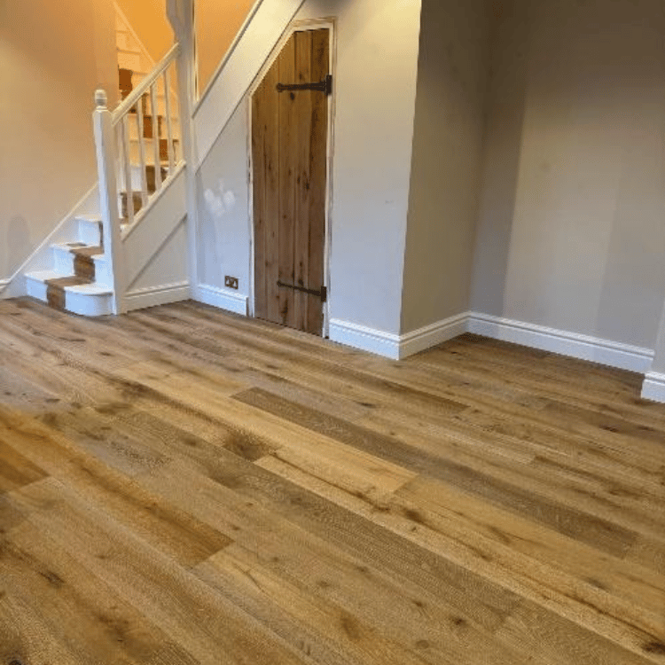 Final finishes on oak floor installation including MDF skirting boards and colour matched solid oak door profiles